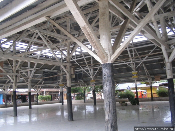 Этот частокол столбов — не что иное, как деревенский автовокзал. Впрочем, когда нет дождя, все предпочитают ждать транспорта на улице. Обратите внимание на чистоту Суматра, Индонезия