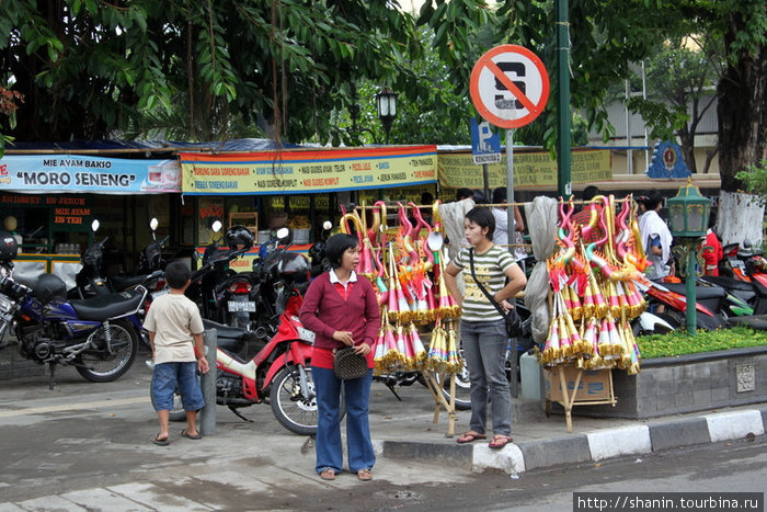 Торговка дудками на улице Джокьякарта, Индонезия