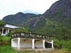 Постройки монастыря под горой с водопадом