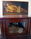 вверху портрет, внизу  уже оригинал (настоящие тело и одежда), лежит несколько столетий