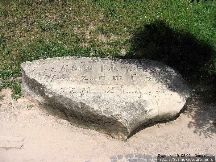 На огромном плоском камне высечено несколько строк странного текста готическим шрифтом. Что именно написано расшифровать не может никто. Золочев, Украина