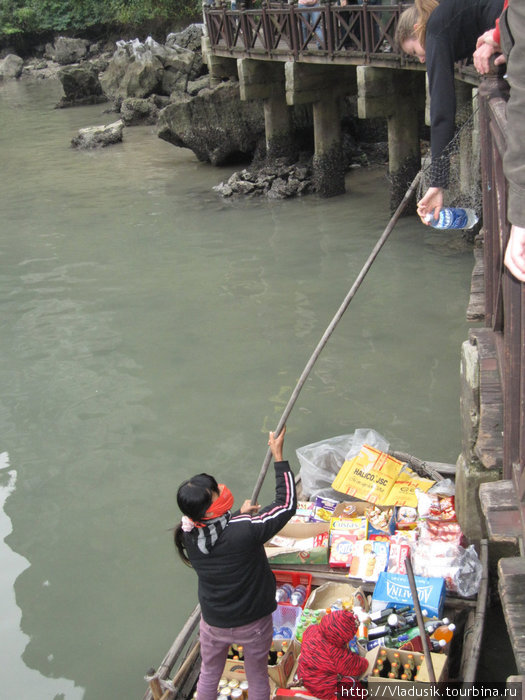 Товароденежный обмен на воде осуществляется с помощью сачка Халонг бухта, Вьетнам