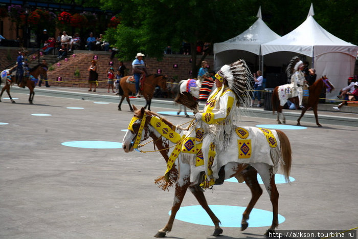 Индейцы зашли на сцену цепочкой, демонстрируя своё убранство. Банфф, Канада